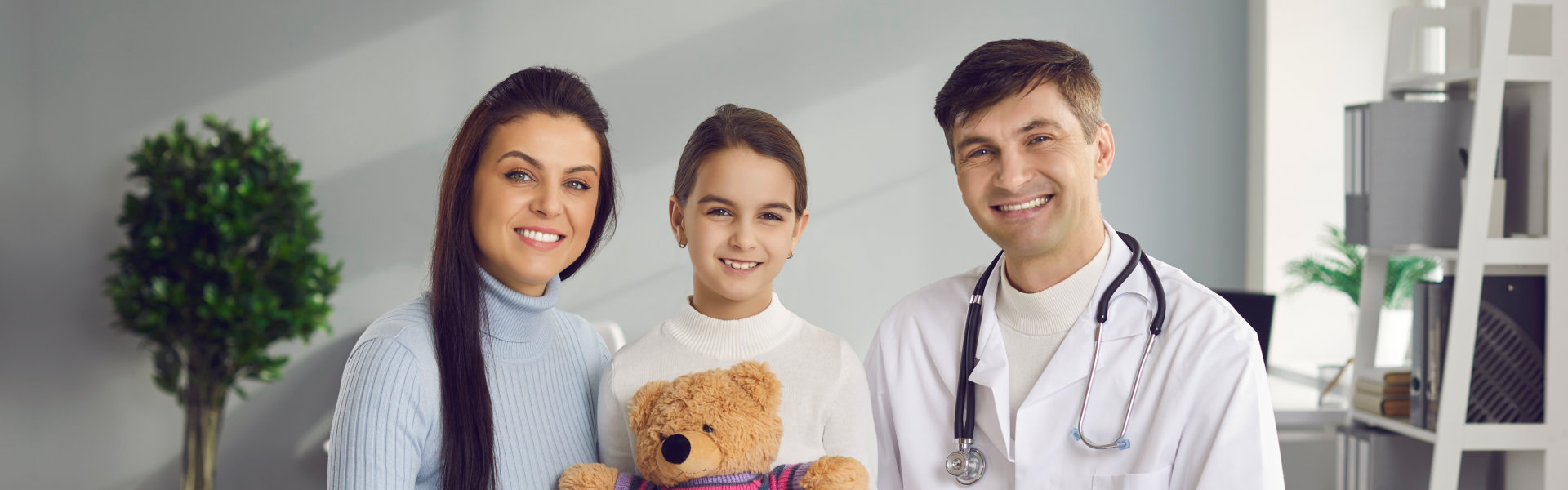 Female parent with her child and a doctor