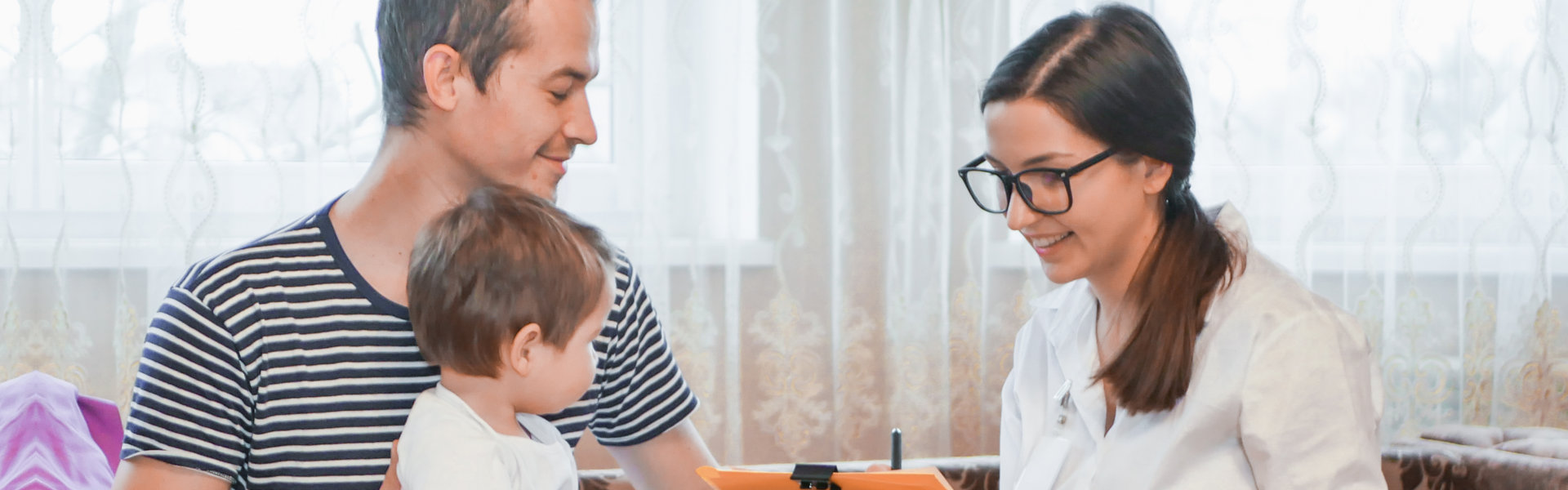 Father with his child and a female doctor